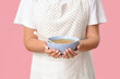 © Pixel-Shot - Young housewife with tasty soup on pink background, closeup