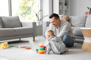 Canvas Print - Father showing his son laptop at home