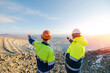© Parilov - Mining Engineers worker on Open Pit Quarry overlooking ore mine, back view