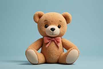 there is a teddy bear with a bow tie sitting on a blue surface