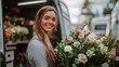 © liliyabatyrova - A joyful young woman with long hair holds a stunning bouquet filled with colorful flowers outside a floral van. She radiates happiness as she prepares for a busy day ahead in the flower shop