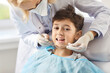 © Studio Romantic - Dentist in the clinic examines a smiling boy, close-up. At the doctor, the child opened his mouth to examine his teeth. Concept dental health in adolescents, dental hygiene , tooth decay