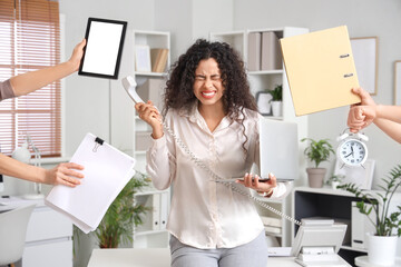 Wall Mural - Stressed African-American businesswoman with a lot of work to do in office. Time management concept