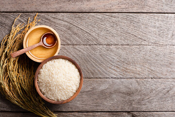 Wall Mural - Rice bran oil on wooden table background. Top view. Flat lay.