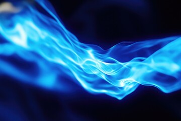 Wall Mural - a blurry image of a blue flame with warm and intense light