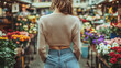 © whitestorm - Vintage-inspired woman explores vibrant flower market in casual spring fashion with high-waisted jeans and light cardigan