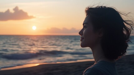 Poster - A person standing alone on the beach during sunset