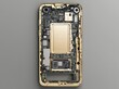 © Georgy - A technician or engineer is taking apart a broken smartphone and removing the logic board for repair or replacement with a new one on the desk.