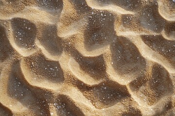 Poster - Close-up of textured sand with wave patterns and small white particles.