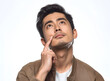 © graphic_titan - A pensive young man gazes upwards, lost in thought, his finger gently touching his cheek. His contemplative expression speaks volumes about the power of introspection and the search for answers