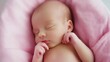 © Morninghead - A peaceful sleeping baby nestled in a soft pink blanket.