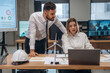 © standret - Laptop and documents on table. Two employees are working in wind turbine company
