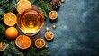 © Fuji - Festive cocktail with citrus fruits and winter greenery on dark background.