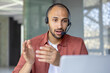 © Liubomir - Man with headset and laptop talking using video call, support service worker at workplace inside office. Advises customers consumers. Business meeting remote conference.