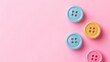 ©  AugmentArt - Colorful Buttons on Soft Pink Background Symbolizing Creative Inspiration and Crafting Beginnings