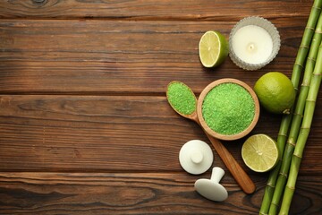 Wall Mural - Spa composition with fresh limes, sea salt and bamboo stems on wooden table, flat lay. Space for text