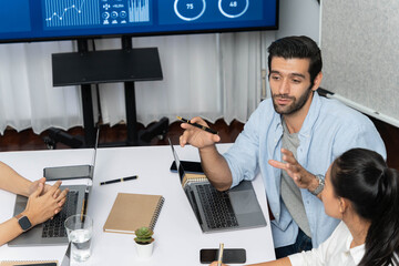 Fototapete - Analyst team utilizing BI Fintech to analyze financial data at table in meeting room. Businesspeople analyzing BI dashboard power on paper for business insight and strategic marketing planning.Prudent