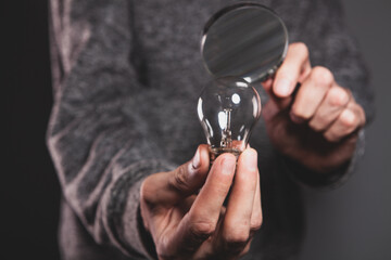 Wall Mural - hand holding a glass of light bulb