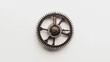 © musa - Close-up view of a single antique metallic gear on a white background.