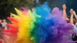 © Tom - A vibrant explosion of colorful powder fills the air, creating a festive atmosphere at an outdoor celebration, with raised hands of diverse participants in the background.