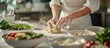 © BerkahStock - Chef's hands kneading dough, surrounded by fresh ingredients.
