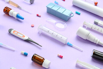 Poster - Composition with pills, thermometers and syringes on lilac background