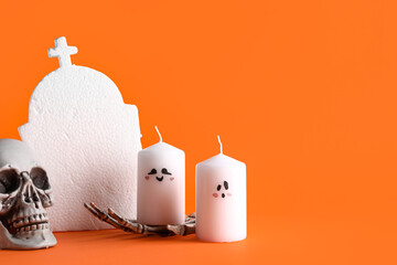 Wall Mural - Wax candles and decor for Halloween on orange background