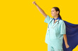 © Pixel-Shot - Beautiful female doctor in superhero costume on yellow background