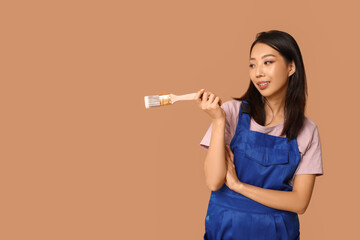 Wall Mural - female asian happy painter with brush on brown background