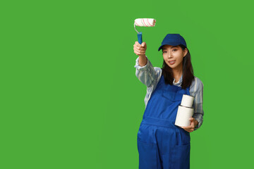 Wall Mural - female asian painter with roller and paint cans on green background
