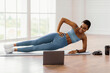 © Prostock-studio - Online Workout. Smiling Sporty Sporty Lady Standing In Plank Position On Floor At Home Training, Looking At Laptop Watching Video Tutorial. Cheerful Lady Exercising. Domestic Fitness Concept