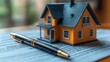 © KAYU - Real Estate Transaction: House Model, Pen, and Legal Documents