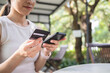© Ton Photographer4289 - Woman hand holding credit card with smartphone for shopping and paying online using banking app.