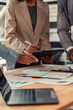 © MrAshi - Group of Asian businessmen brainstorming on team cooperation Happy team meeting meeting room, business and financial data graphs vertical close-up image