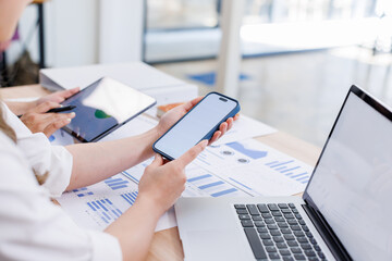 Wall Mural - Close up Business woman using calculator and laptop and phone for do math finance on wooden desk, tax, accounting, statistics and analytical research concept