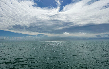 Wall Mural - heaven amazing clouds and sea glittering water.