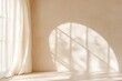 © Kassiopeia  - Soft light pours through a beautifully arched window adorned with sheer linen curtains, creating a calm ambiance on a smooth, beige wall. The expansive negative space enhances the elegance