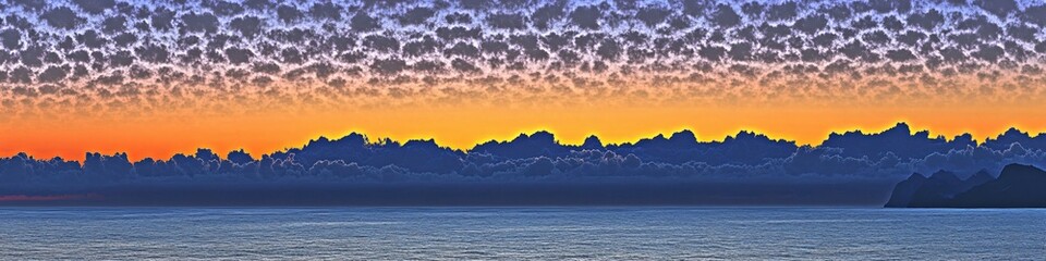 Poster - Dramatic sunset over ocean with dark clouds and orange sky creating a serene landscape