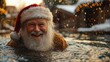 © Danila - Santa Claus, clad in his red hat, swims in the pool, weaving together Christmas cheer and a lively summer mood