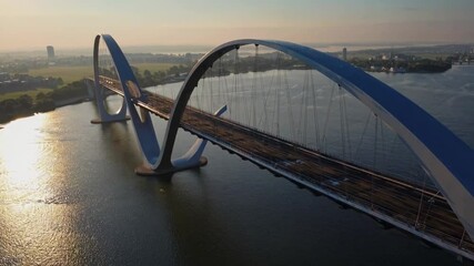 Aufkleber - Stunning aerial view of modern bridge spanning a river in the early morning light