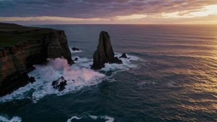 Aufkleber - Dramatic sunset over coastal rock formations with crashing waves and vibrant skies