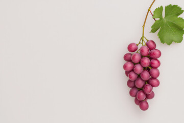 Aufkleber - A minimalist photograph of a single grape hanging from a thin vine against a stark white background, highlighting its natural beauty and simplicity,