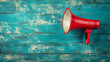 © Vivid_Vision - A red megaphone on an old blue wooden background