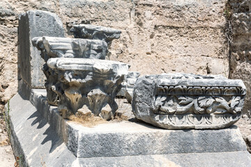 Wall Mural - Close-up of intricately carved stone capitals and fragments of ancient architecture. Perge archaeological site, Turkey (Turkiye)