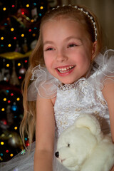 Wall Mural - little girl decorating christmas tree