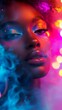 © Denys - Beauty portrait of african american woman with creative makeup posing in colorful neon lights and smoke