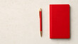 © ชัยธวัช ผาผง - Writing inspiration red notebook and pen on minimalist desk creative workspace flat lay view