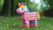 © Santri - Whimsical Rainbow Unicorn Pi?ata in a Vibrant Outdoor Setting