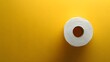 © horizon - Toilet paper roll positioned against pale yellow backdrop showcases textured paper detail with right-aligned placement and soft shadow effects.