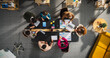 © Gorodenkoff - Top Down View: Startup Meeting Room with Team of Diverse Entrepreneurs Sitting at the Conference Table to Discuss Problems, Use Tablet and Laptop Computers, Share Documents with Business Statistics